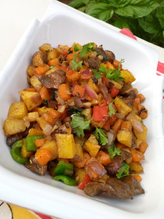 A picture of Stir fried potatoes with veggies and gizzard.