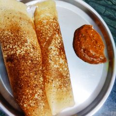 A picture of Rava Dosa With Red chutney.
