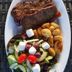 Sirloin Steaks with fried baby potatoes & a greek salad A picture of Sirloin Steaks with fried baby potatoes & a greek salad.
