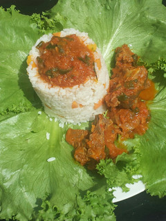 A picture of Rice and goat meat stew in lettuce.