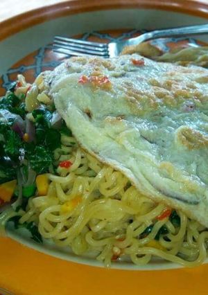 A picture of Garnished Noddle's with pumpkin leaf and egg.