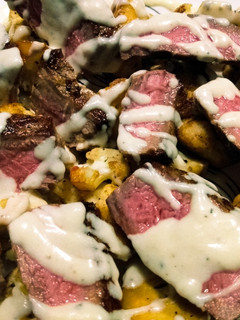 A picture of Beef and cauliflower with creamy parmesan sauce.