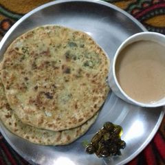 A picture of Gobhi Paranthe with chai.