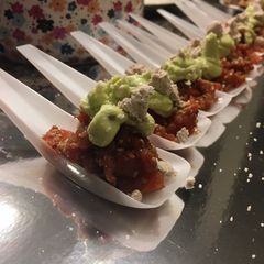 A picture of King Salmon Asian Tartare with avocado cream and olive oil powder.