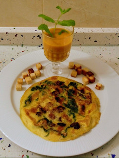Una foto de Tortilla de espinacas, nueces y arándanos con crema de zanahoria y apio
