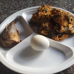 A picture of Yam porriage with vegetable,fried fish and boiled egg.