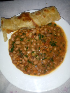 A picture of Carrot chapati served with yellow beans.