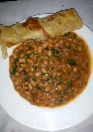 A picture of Carrot chapati served with yellow beans.