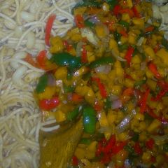A picture of Pasta with stir fried vegetables and shredded fish.