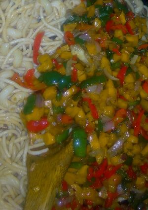 A picture of Pasta with stir fried vegetables and shredded fish.