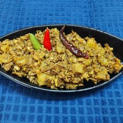 A picture of Banana Flower Dry Curry or Mochar Ghonto.