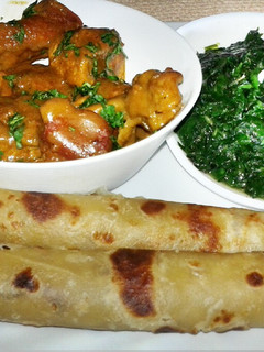 A picture of Coconut chicken and soft layerd chapati.
