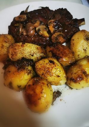 A picture of Pork Chops with Honey, Soy Sauce, Mustard, and Lemon Baby Potatoes in a Dutch Oven.