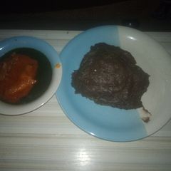 A picture of Yam flour (AMala) and ewedu with stew.