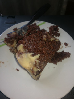 A picture of Chocolate poke cake with white chocolate frosting.
