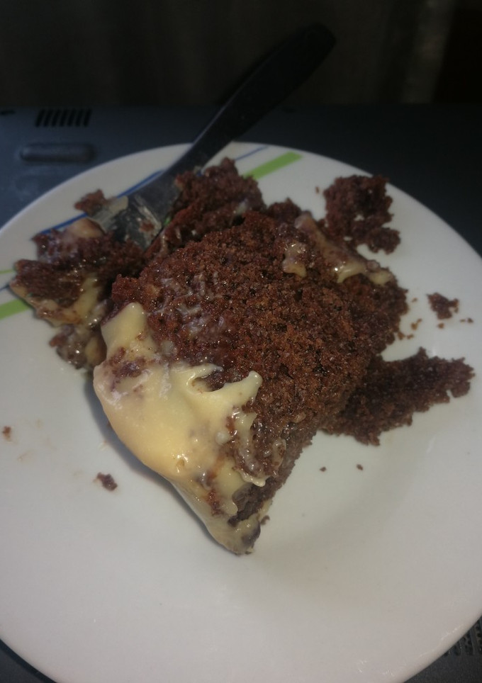 A picture of Chocolate poke cake with white chocolate frosting.