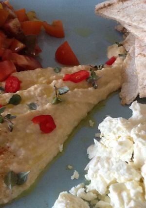 A picture of Hummus and flat bread.