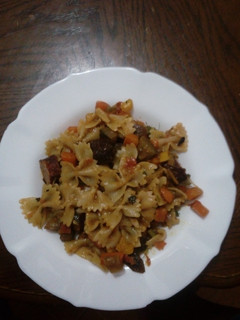 A picture of Veggetable and beef sausages with pasta.