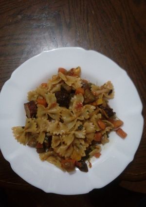 A picture of Veggetable and beef sausages with pasta.