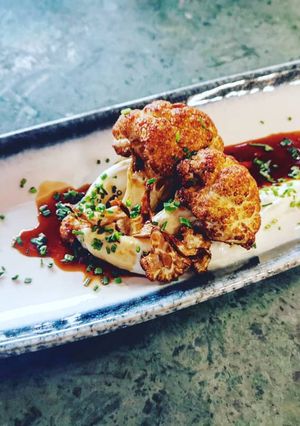 A picture of Crispy Cauliflower chevre cheese sauce glaze with sweet ponzu.