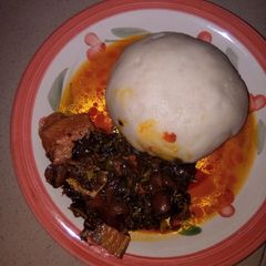 A picture of Pounded yam and vegetable soup.
