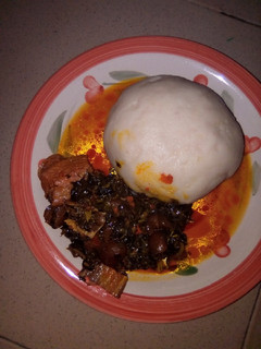 A picture of Pounded yam and vegetable soup.