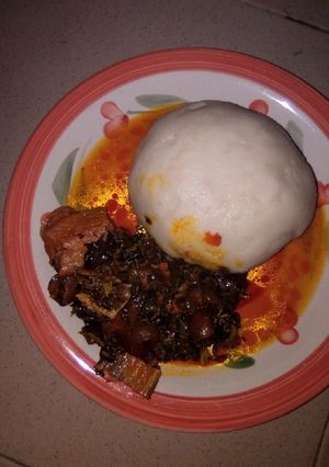 A picture of Pounded yam and vegetable soup.
