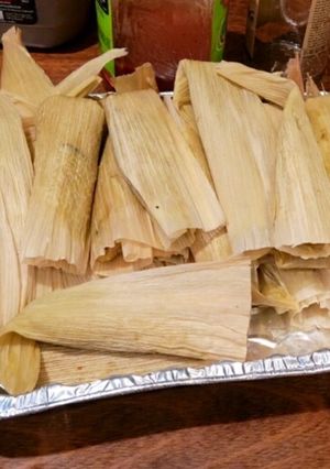 A picture of Pork and Potato Tamales with Green Chile Sauce (Salsa Verde).