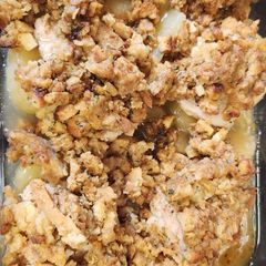 A picture of Pork chops with apples and stuffing.