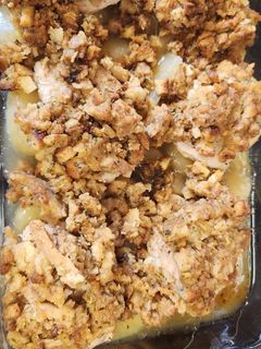 A picture of Pork chops with apples and stuffing.