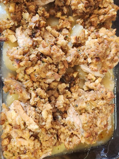 A picture of Pork chops with apples and stuffing.