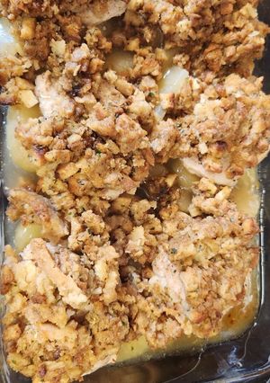 A picture of Pork chops with apples and stuffing.
