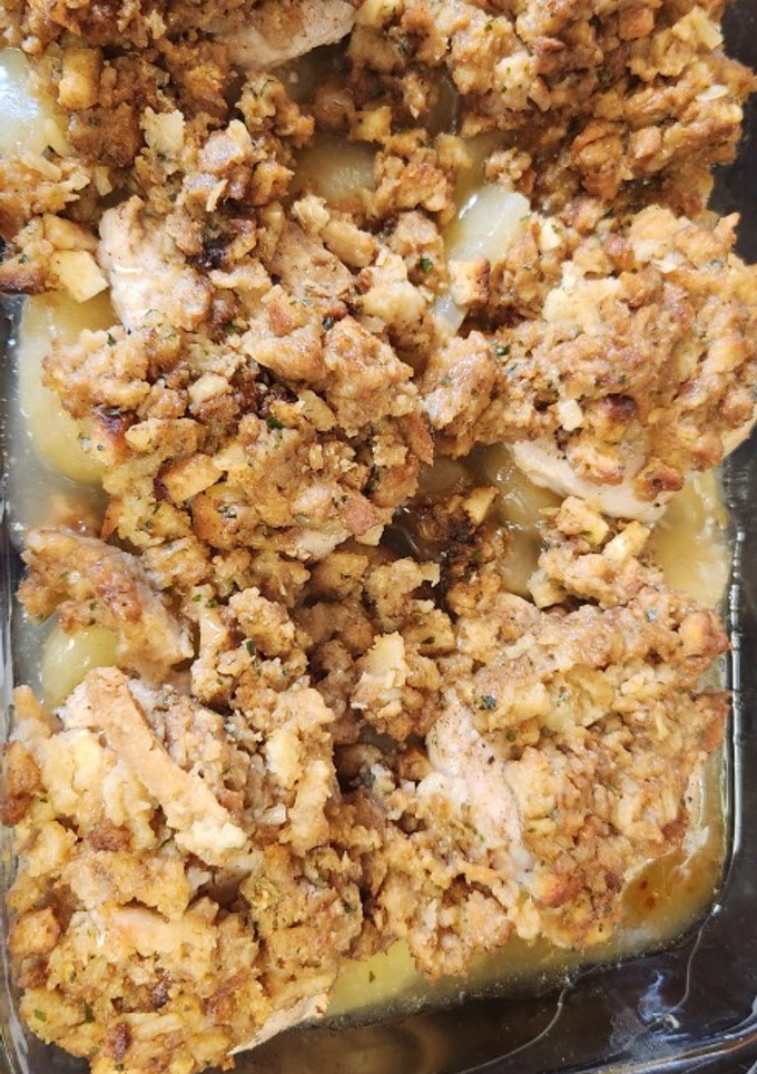 A picture of Pork chops with apples and stuffing.