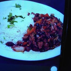 A picture of Beef stew and rice.