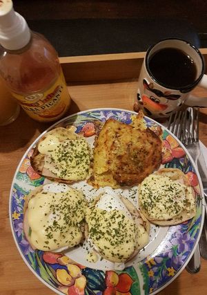 A picture of Eggs Benedict with Spinach and Hash Browns.