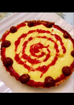 A picture of Mango custard in baked tart with caramel sauce.