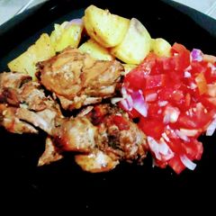 A picture of Oven baked potatoes and chicken.
