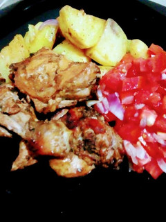A picture of Oven baked potatoes and chicken.
