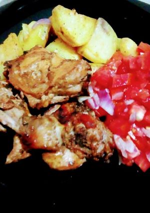 A picture of Oven baked potatoes and chicken.