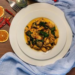 A picture of Chicken stir fry with basil leave.