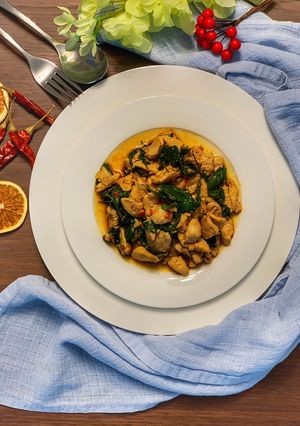 A picture of Chicken stir fry with basil leave.
