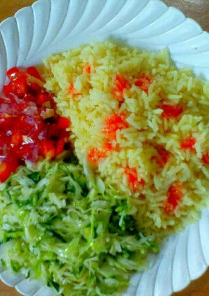 A picture of Coconut rice with buttered cabbage and Kachumbari.