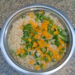 A picture of Steamed rice with peppers.
