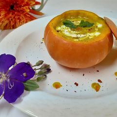 A picture of Pumpkin soup in pumpkin bowl.