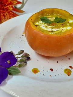 A picture of Pumpkin soup in pumpkin bowl.