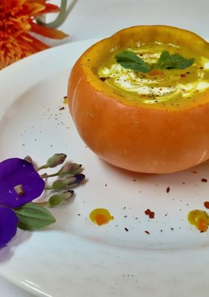 A picture of Pumpkin soup in pumpkin bowl.