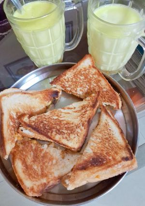 A picture of Cheese,potatoes,onion toast sandwich 🍞 with Haldi wala milk.