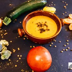 A picture of Yellow lentils soup with vegetables.