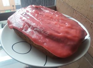 Una foto de Pan🥧 de plátano🍌 con frosting de cereza🍒.