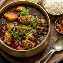 A picture of Bengali Style Murgi Laal Jhol (Chicken curry).